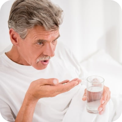 Elderly man taking medicine