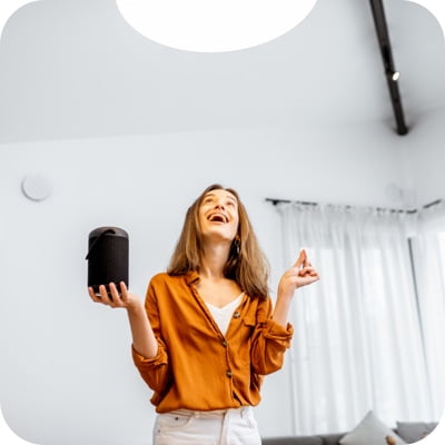 Woman holding smart speaker
