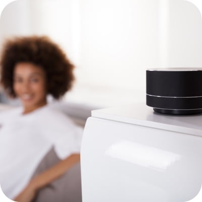 Woman looking at smart speaker
